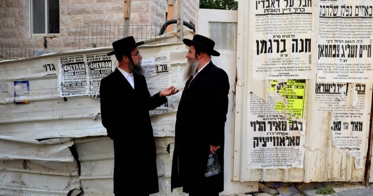A quiet street of stone houses and wall posters in Mea Shearim on a Jerusalem neighbourhood tour
