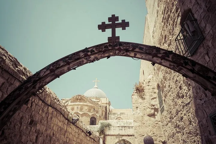 Pilgrims walking a stone lane of the Via Dolorosa on an in-the-footsteps-of-Jesus Jerusalem tour